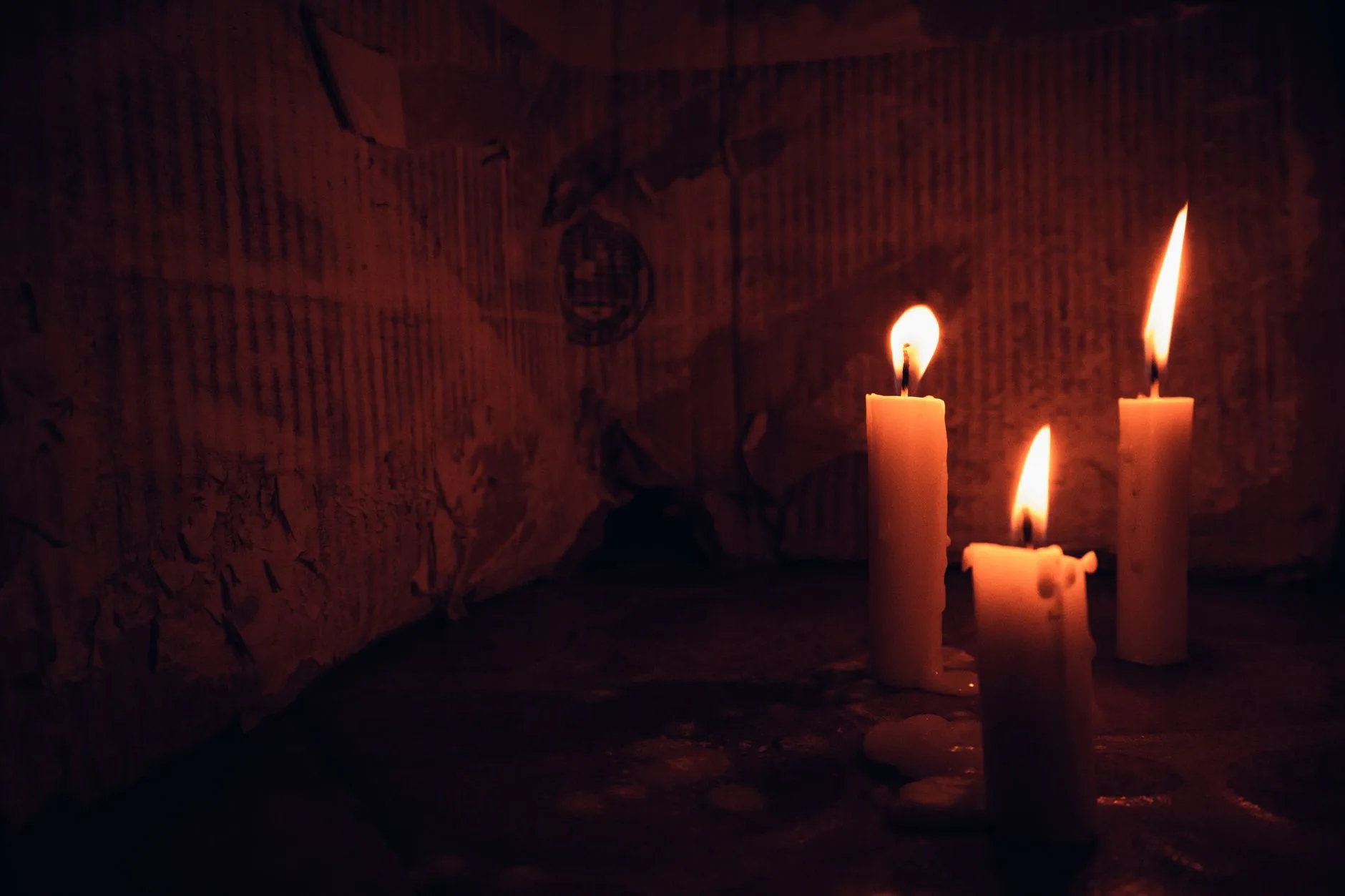 A candle burning in a dark room