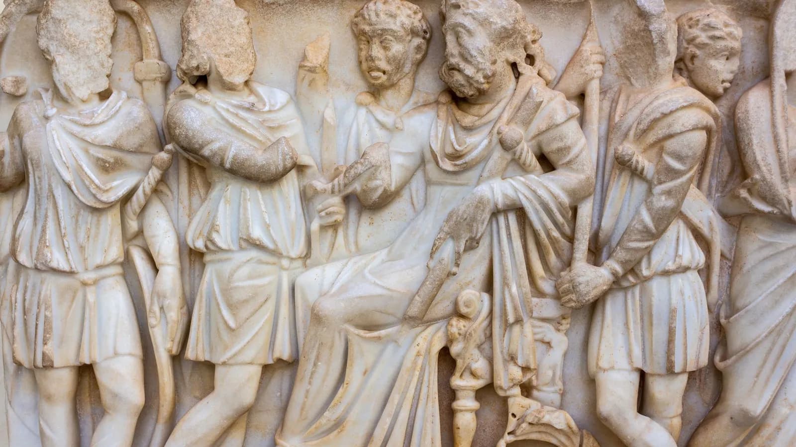 Ancient Roman marble relief showcasing historical figures in classical attire.