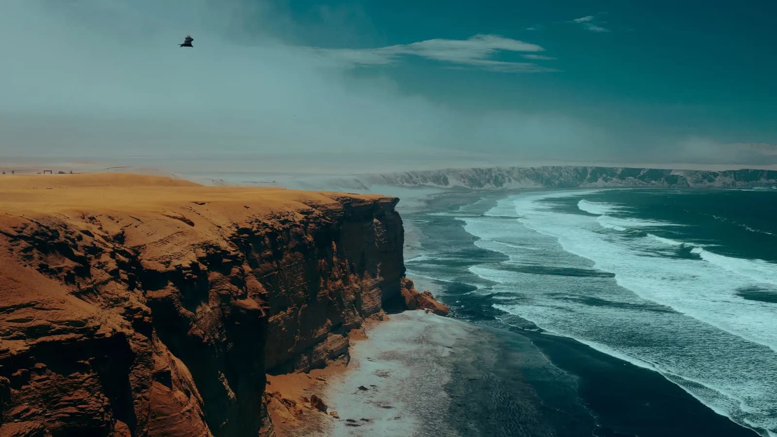A breathtaking view of Peru's coastal cliffs meeting the Pacific Ocean, showcasing natural beauty.