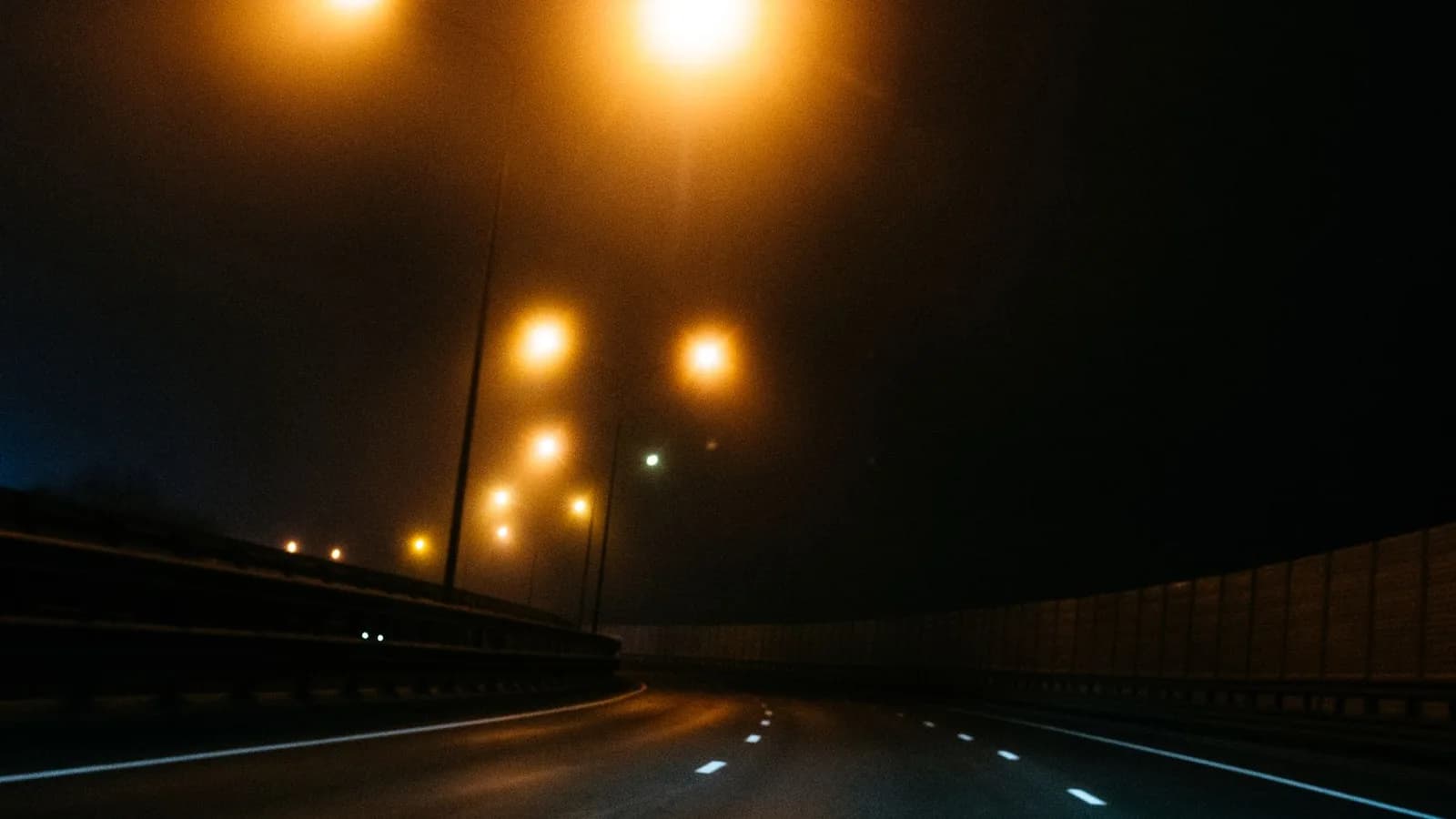 A dark highway through forest