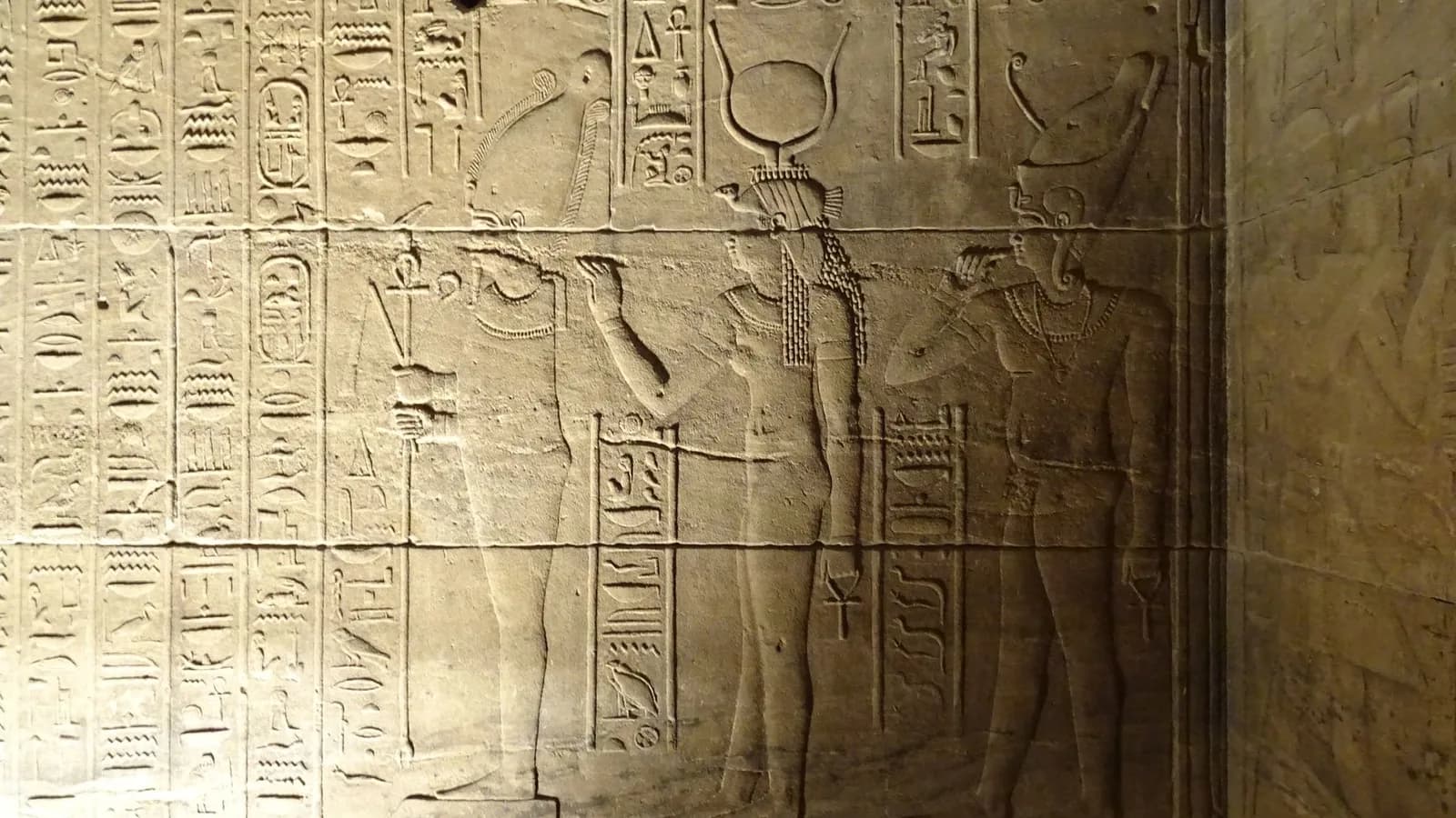 Carved hieroglyphic relief on an Egyptian temple wall