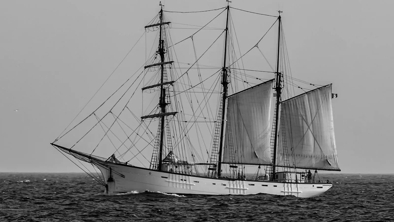 A sailing ship under canvas at sea