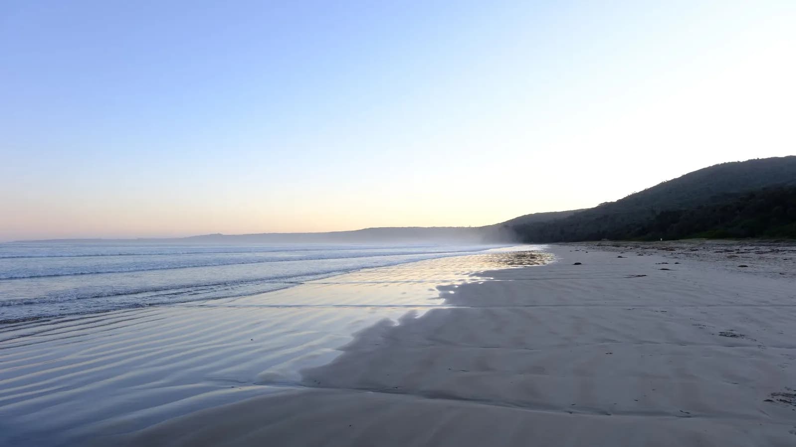 An empty beach at dawn