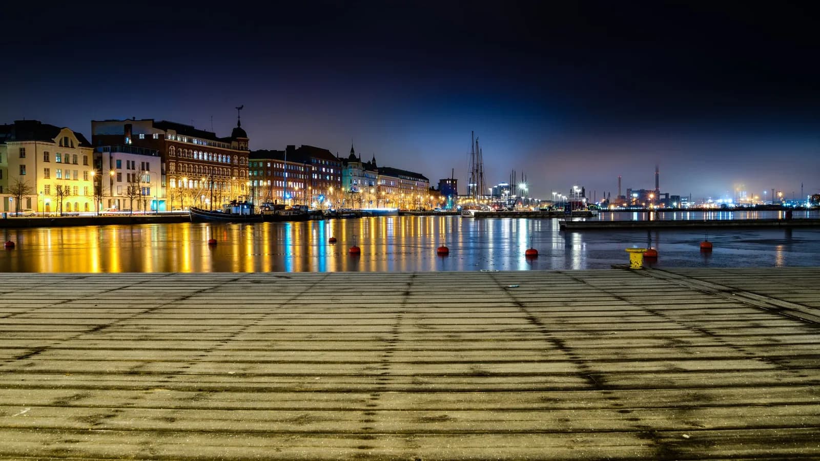 A pier over dark water at night